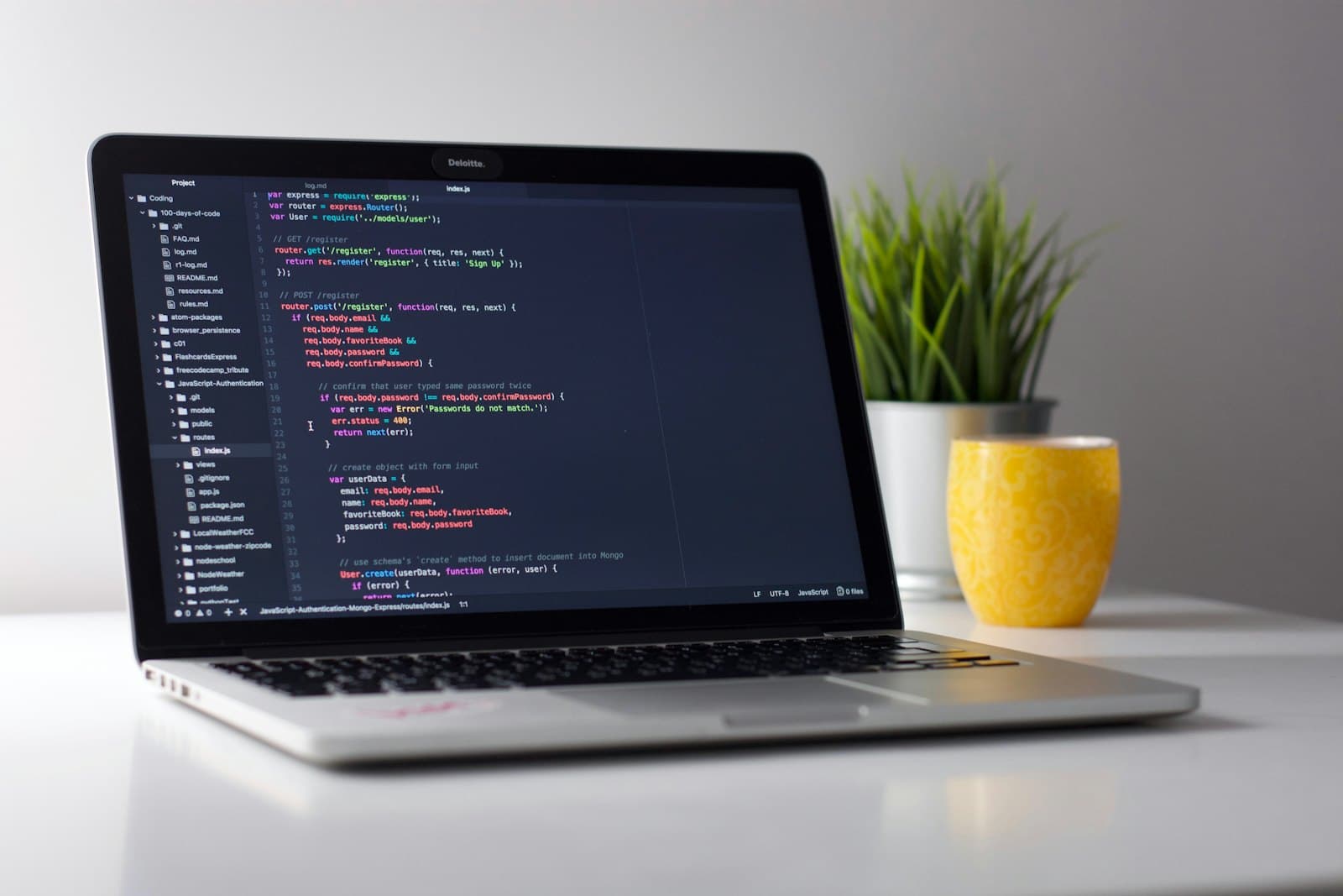 Developer writing code on a laptop